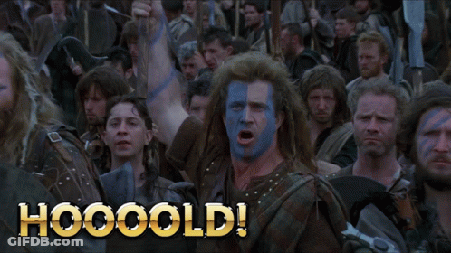 A Man With Blue And White Paint On His Face Stands In Front Of A Crowd With The Words Hooooold Written On The Bottom GIF