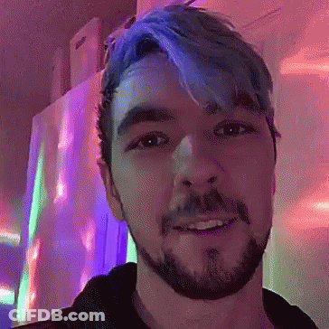 A Man With Blue Hair And A Beard Smiles GIF