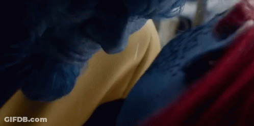A Man With Blue Hair And A Woman With Red Hair Are Standing Next To Each Other . GIF