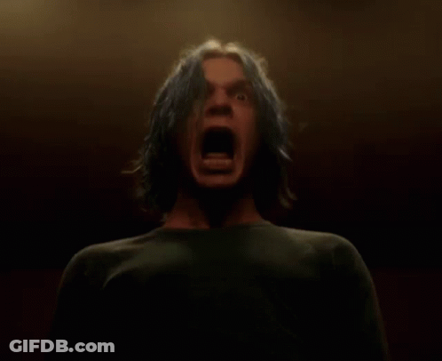A Man With Blue Hair Is Screaming Into The Camera GIF