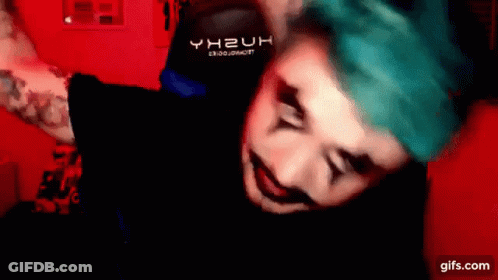 A Man With Blue Hair Is Wearing A Black Shirt That Says Yh2uh On It . GIF