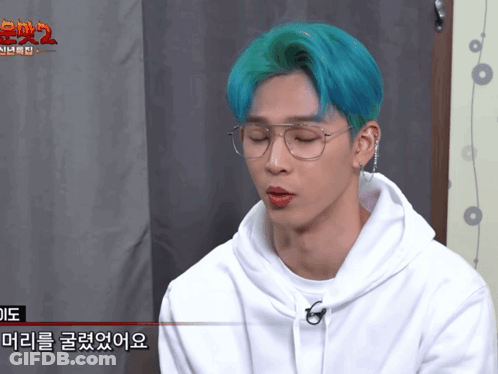 A Man With Blue Hair Wearing Glasses And A White Hoodie GIF