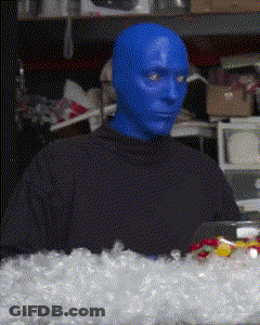 A Man With Blue Paint On His Face Is Sitting In Front Of A Pile Of Ice GIF