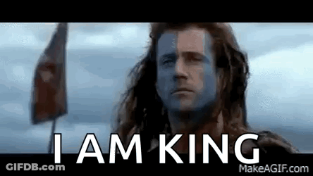 A Man With Blue Paint On His Face Is Standing In Front Of A Flag . GIF