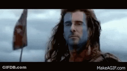 Man With Blue Face Paint Standing In Front Of Flag GIF