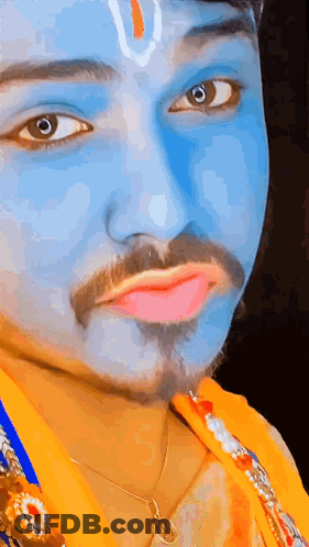 A Man With Blue Paint On His Face Is Wearing A Necklace . GIF