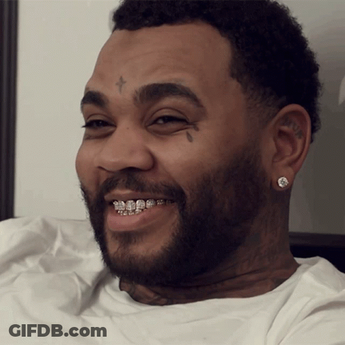 A Man With Braces On His Teeth Has A Cross On His Forehead GIF