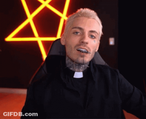 A Man With Braces On His Teeth Is Sitting In A Chair In Front Of A Neon Pentagram . GIF