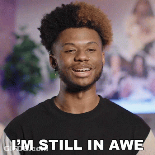 A Man With Braces On His Teeth Is Smiling And Says " I 'M Still In Awe " GIF