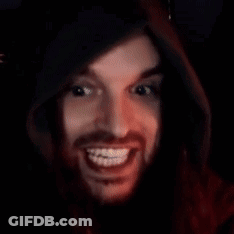 A Man With Braces On His Teeth Is Smiling In A Dark Room . GIF