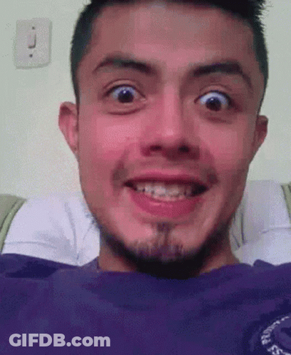 A Man With Braces On His Teeth Is Smiling With His Mouth Open GIF