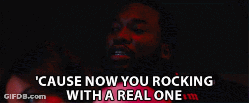 A Man With Braces On His Teeth Says " Cause Now You Rocking With A Real One " In A Dark Room GIF