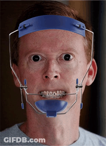 A Man With Braces On His Teeth Wearing A Blue Headband GIF