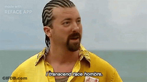 A Man With Braids And A Beard Is Wearing A Yellow Shirt And Says `` I Transcend Race Hombre . '' GIF