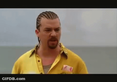 A Man With Braids And A Beard Is Wearing A Yellow Shirt GIF