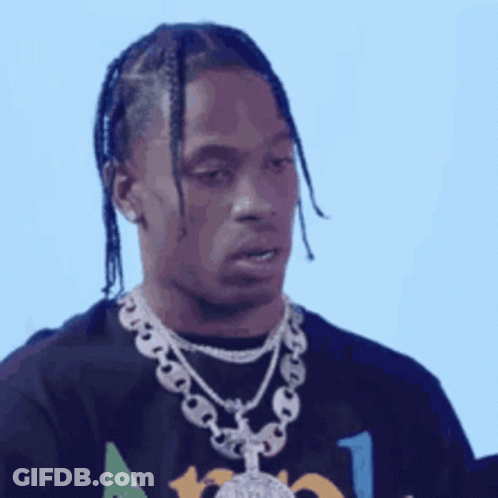 A Man With Braids Is Wearing A Black Shirt And A Silver Chain Around His Neck . GIF
