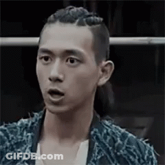 A Man With Braids On His Head Is Making A Surprised Face . GIF