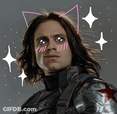 A Man With Cat Ears Drawn On His Face Looks At The Camera GIF