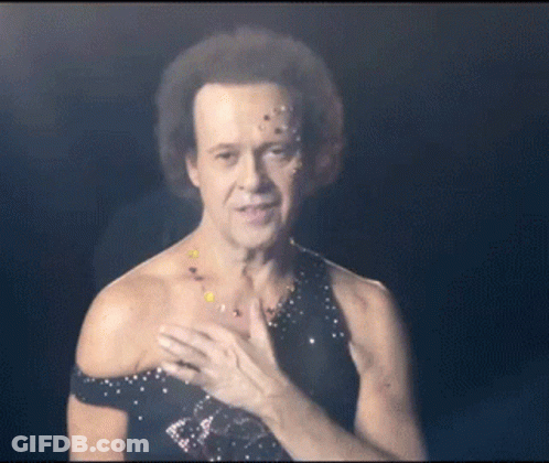 A Man With Confetti On His Face Is Wearing A Black Top GIF
