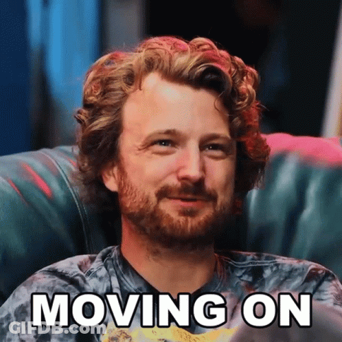 A Man With Curly Hair And A Beard Is Sitting On A Couch With The Words " Moving On " Above Him GIF