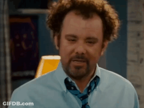 A Man With Curly Hair And A Beard Is Wearing A Blue Shirt And A Blue Tie . GIF