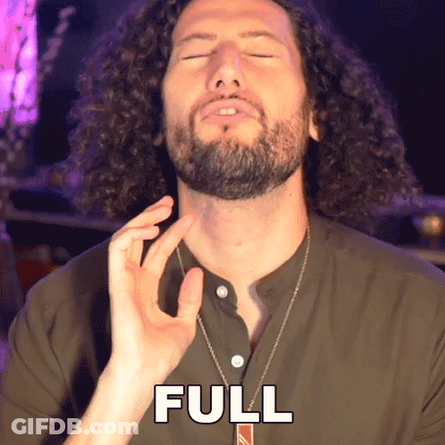 A Man With Curly Hair And A Beard Is Wearing A Necklace That Says Full GIF