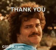 A Man With Curly Hair And A Mustache Is Making A Thank You Face . GIF