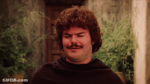 A Man With Curly Hair And A Mustache Making A Face GIF