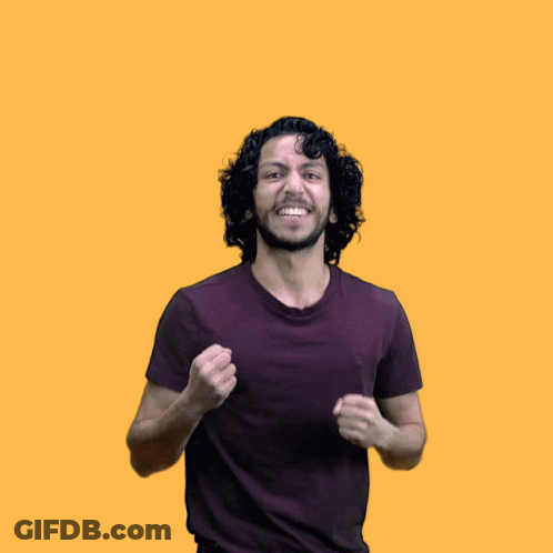 A Man With Curly Hair And A Purple Shirt Is Raising His Arms In The Air GIF