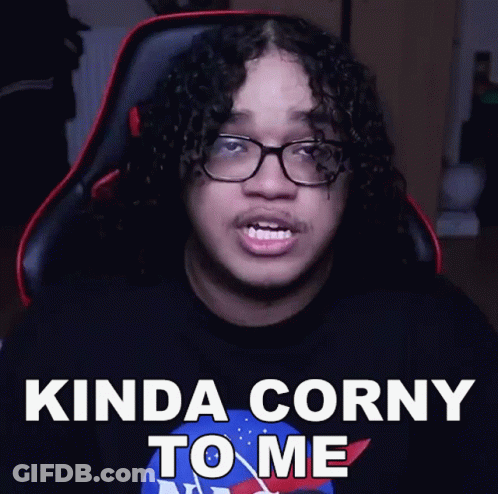 A Man With Curly Hair And Glasses Is Sitting In A Chair And Says Kinda Corny To Me GIF