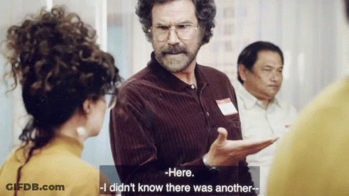 A Man With Curly Hair And Glasses Is Talking To A Woman Who Says Here I Did N't Know There Was Another GIF