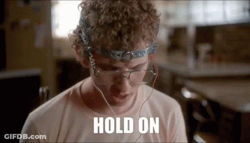 A Man With Curly Hair And Glasses Is Wearing Headphones And A Headband . GIF