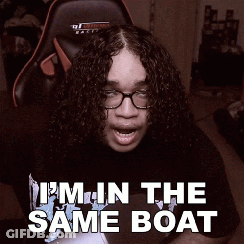 A Man With Curly Hair And Glasses Says " I 'M In The Same Boat " While Sitting In A Gaming Chair GIF