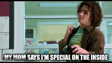 A Man With Curly Hair Is Holding A Camera And Says " My Mom Says I 'M Special On The Inside " . GIF