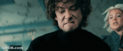 A Man With Curly Hair Is Making A Face While A Woman Looks On GIF