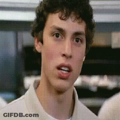 A Man With Curly Hair Is Making A Funny Face GIF