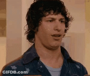 Man With Curly Hair Making Funny Face In Blue Shirt GIF