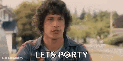 A Man With Curly Hair Is Sitting In A Park With The Words `` Lets Porty '' Written On His Face . GIF