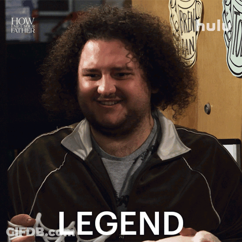 A Man With Curly Hair Is Smiling And Holding A Hot Dog In Front Of A Sign That Says " How I Met Your Father " GIF