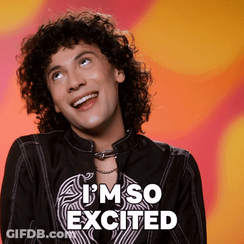 A Man With Curly Hair Is Smiling With The Words I 'M So Excited Behind Him GIF