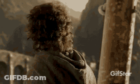A Man With Curly Hair Is Standing In Front Of A Mountain And A Sign That Says Gifstar On It GIF