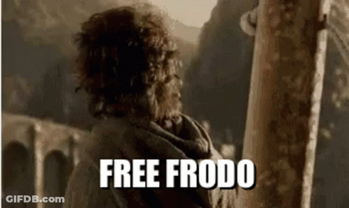 A Man With Curly Hair Is Standing Next To A Pole With The Words `` Free Frodo '' On It . GIF