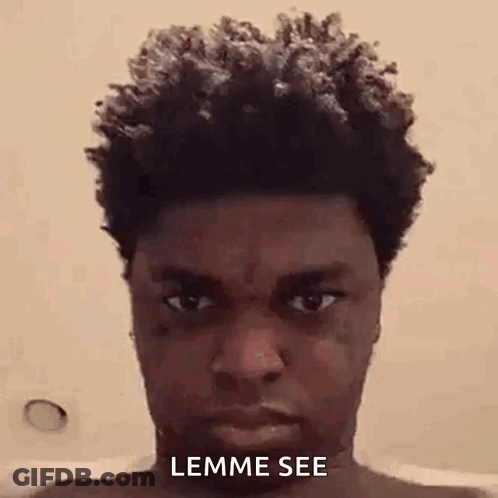 A Man With Curly Hair Is Taking A Selfie In A Bathtub . GIF