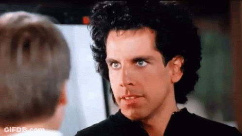 A Man With Curly Hair Is Talking To Another Man In A Movie . GIF