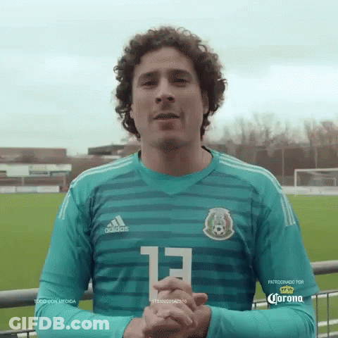 A Man With Curly Hair Is Wearing A Green Adidas Jersey With The Number 13 On It GIF