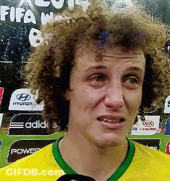 A Man With Curly Hair Is Wearing A Yellow And Green Shirt With A Green Collar GIF