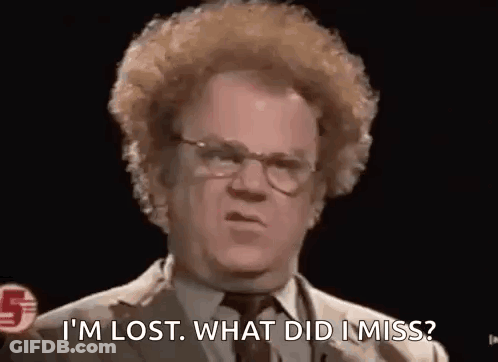 A Man With Curly Hair Is Wearing Glasses And A Suit And Tie . GIF