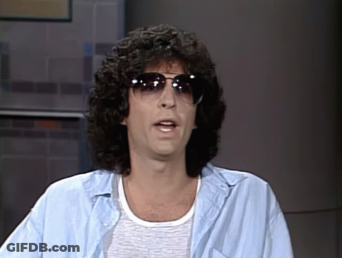 A Man With Curly Hair Is Wearing Sunglasses And A Light Blue Shirt GIF