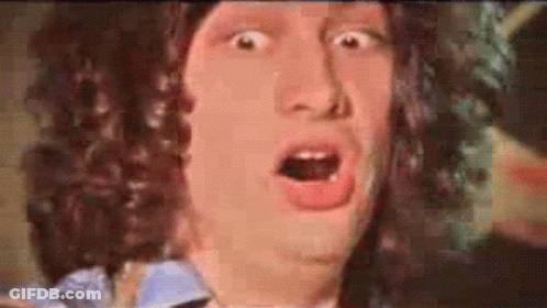 A Man With Curly Hair Making A Surprised Face GIF