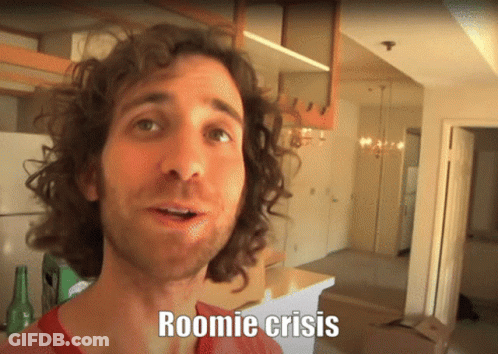 A Man With Curly Hair Says Roomie Crisis In Front Of An Empty Kitchen GIF